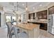 Spacious kitchen with granite countertops, stainless steel appliances, seating, and coffered ceilings at 664 Rotonda Cir, Rotonda West, FL 33947