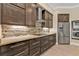 Well-equipped kitchen with granite countertops, stainless steel appliances, and a tile backsplash at 664 Rotonda Cir, Rotonda West, FL 33947