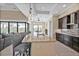 Open kitchen with an island, barstool seating, stainless steel appliances, and tile flooring at 664 Rotonda Cir, Rotonda West, FL 33947