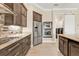 Stylish kitchen with granite countertops, stainless steel appliances, and wood-look tile flooring at 664 Rotonda Cir, Rotonda West, FL 33947