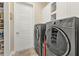 Laundry room with gray washer and dryer and lots of shelving for supplies at 664 Rotonda Cir, Rotonda West, FL 33947