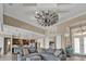 Open living area with windmill ceiling fan, barn doors, a view to the kitchen, and a glimpse of the front entrance at 664 Rotonda Cir, Rotonda West, FL 33947