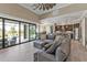 Spacious living room with an open floorplan, overlooking a screened pool and patio area and modern kitchen at 664 Rotonda Cir, Rotonda West, FL 33947