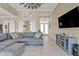 Open floorplan featuring a living room, barn doors, a view of the front door, and a modern entertainment center at 664 Rotonda Cir, Rotonda West, FL 33947