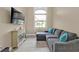 Comfortable living room with a large gray sectional couch, accent pillows, and a flat screen television at 664 Rotonda Cir, Rotonda West, FL 33947