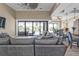 Open-concept living room with a large sectional sofa and sliding glass doors to the pool area at 664 Rotonda Cir, Rotonda West, FL 33947