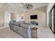 Large living room with a ceiling fan, barn doors, and view to the kitchen area at 664 Rotonda Cir, Rotonda West, FL 33947