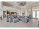 Open-concept living area with a windmill ceiling fan, leading to the kitchen, dining area, and front entrance at 664 Rotonda Cir, Rotonda West, FL 33947