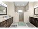 Main bathroom featuring dual vanities and a large walk-in shower at 664 Rotonda Cir, Rotonda West, FL 33947