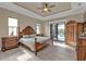 Spacious main bedroom with wood-look floors, a ceiling fan, and access to the screened lanai at 664 Rotonda Cir, Rotonda West, FL 33947