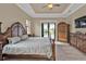 Spacious main bedroom with wood-look floors, a ceiling fan, and access to the screened lanai at 664 Rotonda Cir, Rotonda West, FL 33947