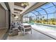 Inviting outdoor seating, adjacent to the refreshing pool and summer kitchen area at 664 Rotonda Cir, Rotonda West, FL 33947