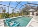 Refreshing pool area with blue chairs and a built-in spa, ideal for outdoor enjoyment at 664 Rotonda Cir, Rotonda West, FL 33947