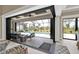 View of the open transition between the main room and the screened-in patio with a pool and seating area at 664 Rotonda Cir, Rotonda West, FL 33947