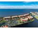 An aerial view of a building complex, tennis courts, and beautiful views of the water at 87 Vivante Blvd # 8732, Punta Gorda, FL 33950