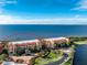 Aerial view of building complex with beautiful views of the water and red tile roofing at 87 Vivante Blvd # 8732, Punta Gorda, FL 33950