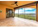 A screened-in balcony reveals a beautiful water view, neutral paint, ceiling fan, and tile flooring at 87 Vivante Blvd # 8732, Punta Gorda, FL 33950