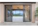 View of the balcony with an ocean view seen through sliding glass doors at 87 Vivante Blvd # 8732, Punta Gorda, FL 33950