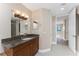 Bathroom features a granite countertop, dark wood cabinets and a decorative vanity mirror at 87 Vivante Blvd # 8732, Punta Gorda, FL 33950