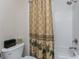 Cozy bathroom featuring a shower-tub combo with a decorative palm tree shower curtain at 87 Vivante Blvd # 8732, Punta Gorda, FL 33950