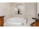 Bright bathroom features a soaking tub and granite counters with tile flooring at 87 Vivante Blvd # 8732, Punta Gorda, FL 33950