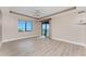 Inviting bedroom features a fan, tray ceiling, and sliding glass doors with scenic water views at 87 Vivante Blvd # 8732, Punta Gorda, FL 33950