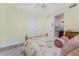 Bedroom with yellow walls featuring a ceiling fan, two closets, and an adjacent bathroom at 87 Vivante Blvd # 8732, Punta Gorda, FL 33950