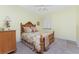 Charming bedroom features a ceiling fan and wooden bed frame with floral bedding at 87 Vivante Blvd # 8732, Punta Gorda, FL 33950