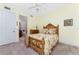 Charming bedroom features a ceiling fan and wooden bed frame with floral bedding at 87 Vivante Blvd # 8732, Punta Gorda, FL 33950