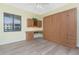 Bright bedroom with vinyl flooring, a Murphy bed, and a desk with a granite countertop at 87 Vivante Blvd # 8732, Punta Gorda, FL 33950