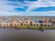 Beautiful waterfront condos on lush green land with bright red tile roofs under a blue sky at 87 Vivante Blvd # 8732, Punta Gorda, FL 33950
