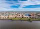 Wide view of the beautiful waterfront condos on lush green land with bright red tile roofs at 87 Vivante Blvd # 8732, Punta Gorda, FL 33950