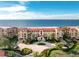 Beautiful exterior shot of a multi-story condominium building with well-manicured landscaping and water views at 87 Vivante Blvd # 8732, Punta Gorda, FL 33950