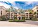 Up close outdoor shot of a condominium building with a beautiful entrance and mature landscaping at 87 Vivante Blvd # 8732, Punta Gorda, FL 33950