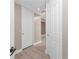 Hallway with hardwood-style flooring, white baseboards, and a view down the hall at 87 Vivante Blvd # 8732, Punta Gorda, FL 33950