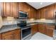 Modern kitchen features stainless steel oven, granite countertops, and ample wood cabinetry at 87 Vivante Blvd # 8732, Punta Gorda, FL 33950