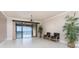 Living room with tile flooring, ceiling fan, and balcony access with waterfront views at 87 Vivante Blvd # 8732, Punta Gorda, FL 33950
