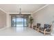 Living room with tile flooring, ceiling fan, and balcony access with waterfront views at 87 Vivante Blvd # 8732, Punta Gorda, FL 33950