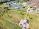Aerial view of the tennis, bocce ball, and community center with manicured lawns at 12905 N Marsh Dr, Port Charlotte, FL 33953