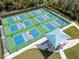 Birds-eye view of several well-maintained pickleball courts, complete with shade structures and accessible pathways at 12905 N Marsh Dr, Port Charlotte, FL 33953