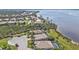 Stunning aerial shot showcasing homes with screened-in pools, lush greenery, and access to a tranquil lake at 12905 N Marsh Dr, Port Charlotte, FL 33953