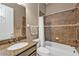 Bathroom featuring a granite vanity, tub, shower, tile accents, and a functional towel rack for a spa-like feel at 12905 N Marsh Dr, Port Charlotte, FL 33953