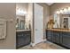 Bathroom featuring a dual sink vanity with granite countertop and warm, neutral walls at 12905 N Marsh Dr, Port Charlotte, FL 33953