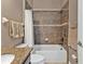 Well-appointed bathroom showcases a tile tub with shower, granite vanity top, and convenient towel storage at 12905 N Marsh Dr, Port Charlotte, FL 33953