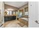 Bathroom featuring a dual sink vanity with granite countertop, tub, and separate shower at 12905 N Marsh Dr, Port Charlotte, FL 33953