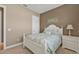 Cozy bedroom with a ceiling fan, a window with plantation shutters, and an inviting white bed frame at 12905 N Marsh Dr, Port Charlotte, FL 33953