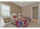 Inviting bedroom with vibrant floral bedding, a window with shutters, and a ceiling fan for added comfort at 12905 N Marsh Dr, Port Charlotte, FL 33953