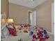 Bright bedroom with two twin beds, floral comforter and lamp at 12905 N Marsh Dr, Port Charlotte, FL 33953