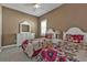 Stylish bedroom with floral bedding, white dressers, a window with shutters, and a ceiling fan for comfort at 12905 N Marsh Dr, Port Charlotte, FL 33953