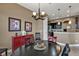Dining room with a black table and chairs adjacent to the kitchen at 12905 N Marsh Dr, Port Charlotte, FL 33953